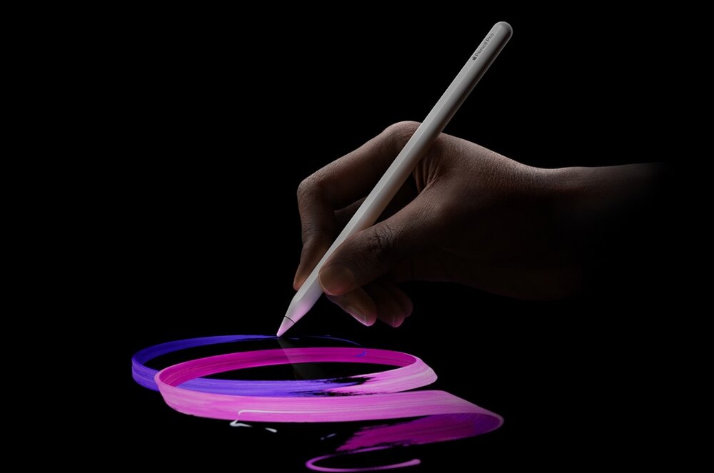 Rysik trzymany w dłoni rysuje kolorowe, różowo-fioletowe linie na czarnym tle. Na rysiku widoczny jest napis \'Pencil\'.