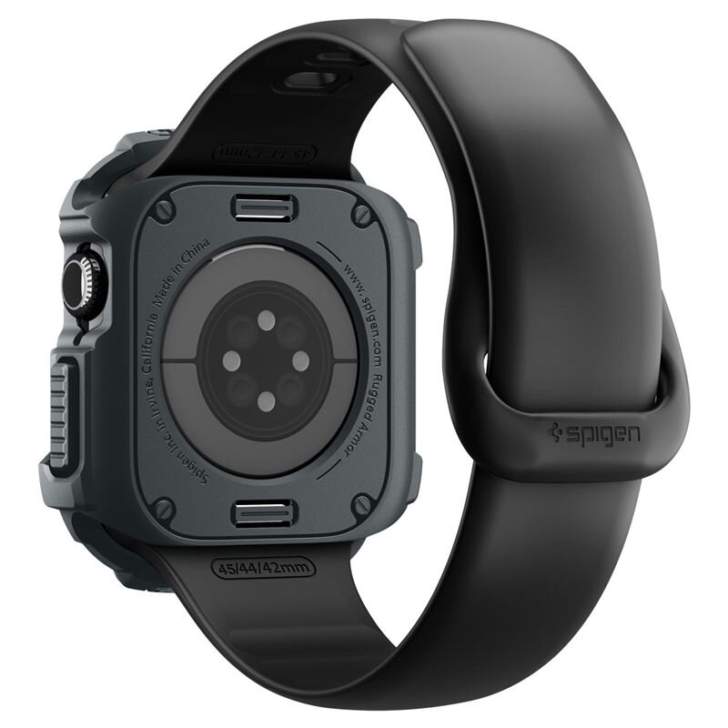 Obraz przedstawia ciemnoszarą obudowę zegarka z czarnym paskiem. Na obudowie widoczny jest napis: \'Spigen.com Rugged Armor\'.