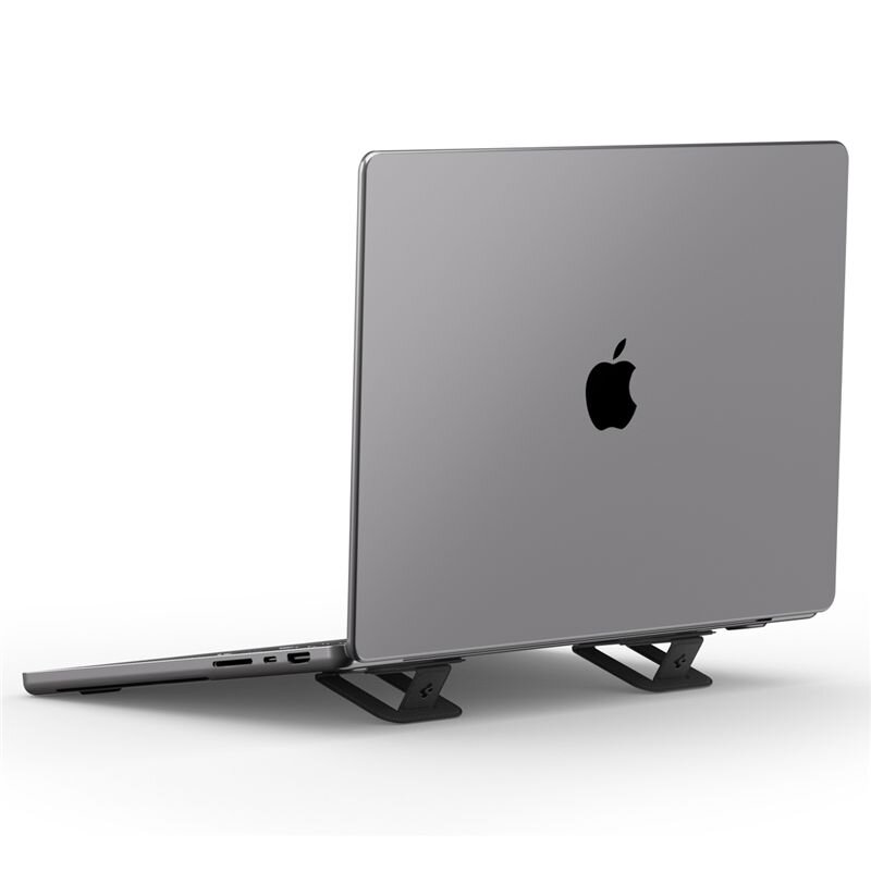 Na obrazie widoczny jest laptop w kolorze srebrnym z logo w kształcie nadgryzionego jabłka, ustawiony na czarnym stojaku. Stojak ma prostą konstrukcję i podtrzymuje laptopa w lekko uniesionej pozycji.