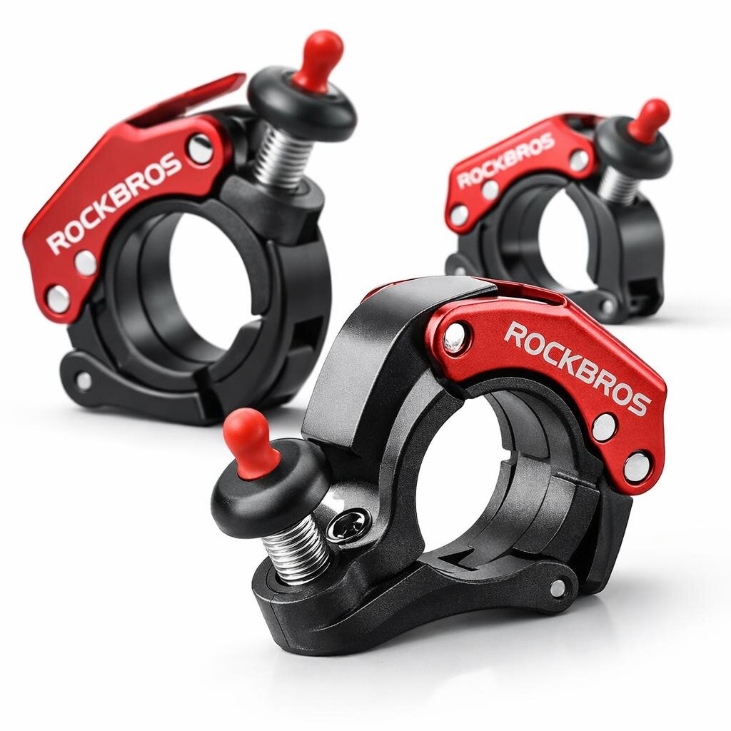 Na obrazie widoczne są trzy mechaniczne dzwonki rowerowe z czerwonymi elementami i napisem \'ROCKBROS\'. Dzwonki mają czarną podstawę i srebrne śruby mocujące.