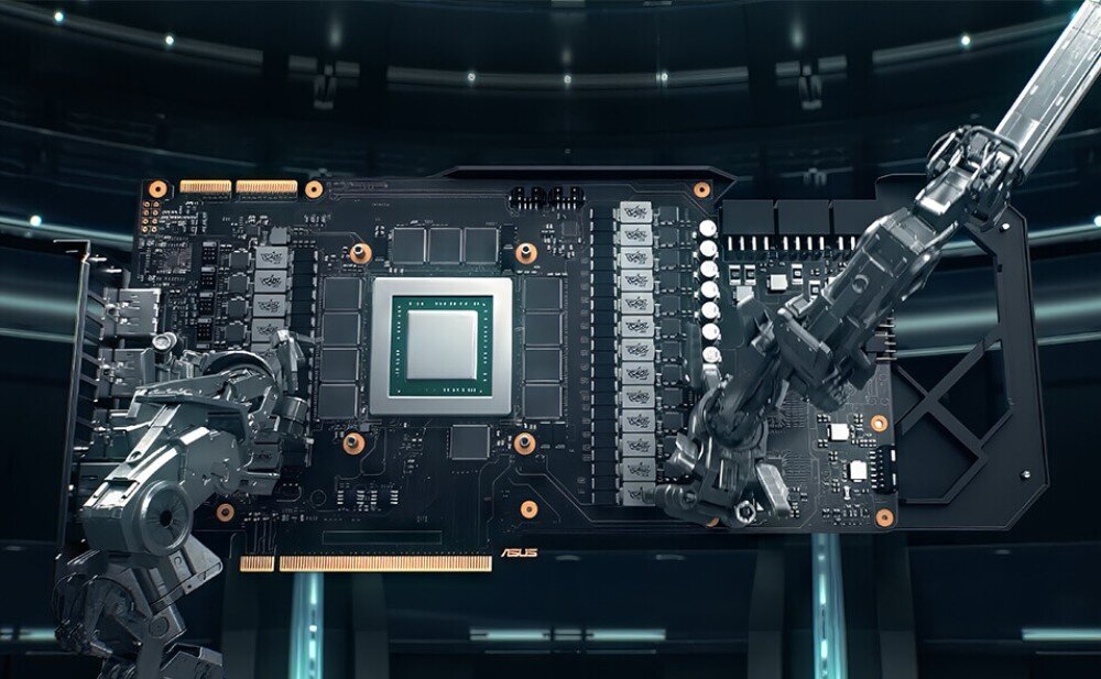 Obraz przedstawia płytę główną karty graficznej z widocznymi elementami elektronicznymi i dwoma mechanicznymi ramionami. Na płycie znajduje się logo ASUS.