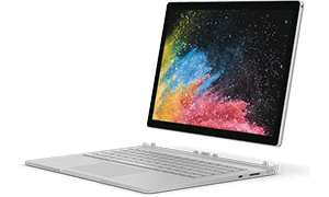 Laptop z odłączanym ekranem, na którym widoczna jest kolorowa grafika z rozpryskiem farb. Urządzenie ma srebrną obudowę i klawiaturę.