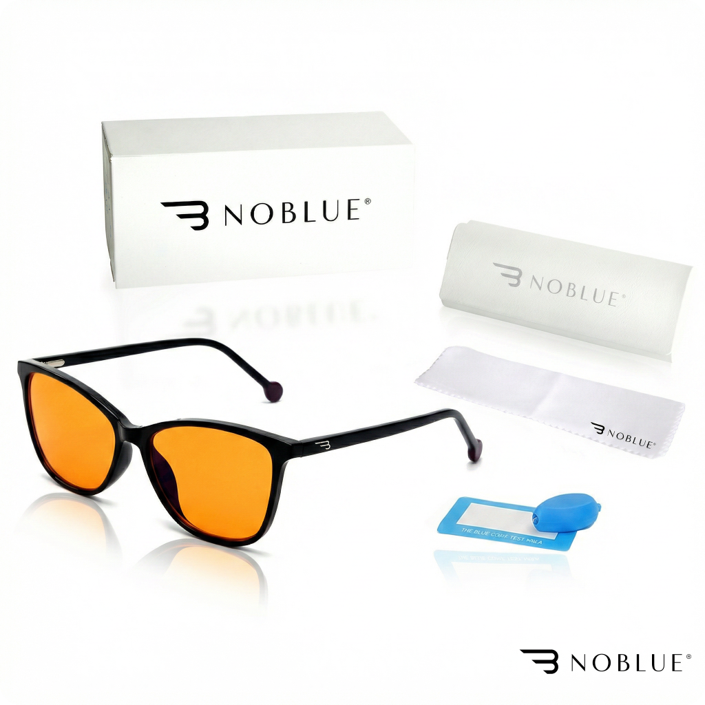 Na obrazie widoczne są okulary z pomarańczowymi soczewkami, pudełko z napisem \'NOBLUE\', etui, ściereczka oraz niebieski przyrząd testowy. Logo \'NOBLUE\' jest widoczne na kilku elementach zestawu.