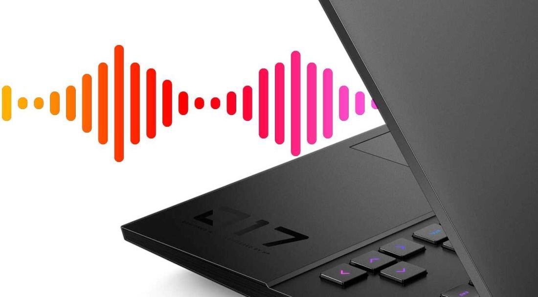 Częściowo otwarty laptop z widoczną klawiaturą i napisem \'17\' na obudowie. W tle kolorowe fale dźwiękowe w odcieniach pomarańczowego i różowego.