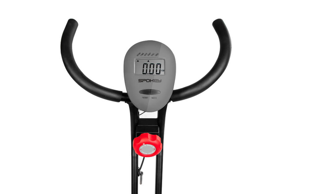 Kierownica roweru magnetycznego z wyświetlaczem pokazującym \'0.00\'. Widoczne logo \'SPOKEY\' oraz czerwony element regulacyjny poniżej.