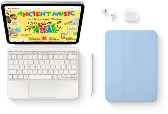 Na obrazie widoczny jest tablet z kolorowym ekranem, klawiatura, rysik, etui w kolorze niebieskim oraz słuchawki bezprzewodowe z etui. Na ekranie tabletu wyświetlana jest strona z napisem \'ANCIENT MUSIC Lost Instruments Revived\'.