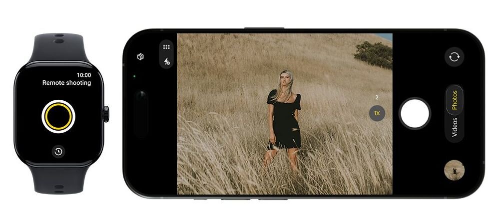 Grafika przedstawia funkcję zdalnego sterowania aparatem za pomocą smartwatcha. Po lewej stronie widoczny jest czarny smartwatch z ekranem Remote shooting i przyciskiem migawki. Po prawej stronie pokazano smartfon w trybie aparatu, z podglądem zdjęcia osoby stojącej w wysokiej trawie oraz przyciskami do robienia zdjęć i nagrywania wideo. Grafika pokazuje, że zegarek może służyć jako pilot do wykonywania zdjęć telefonem.