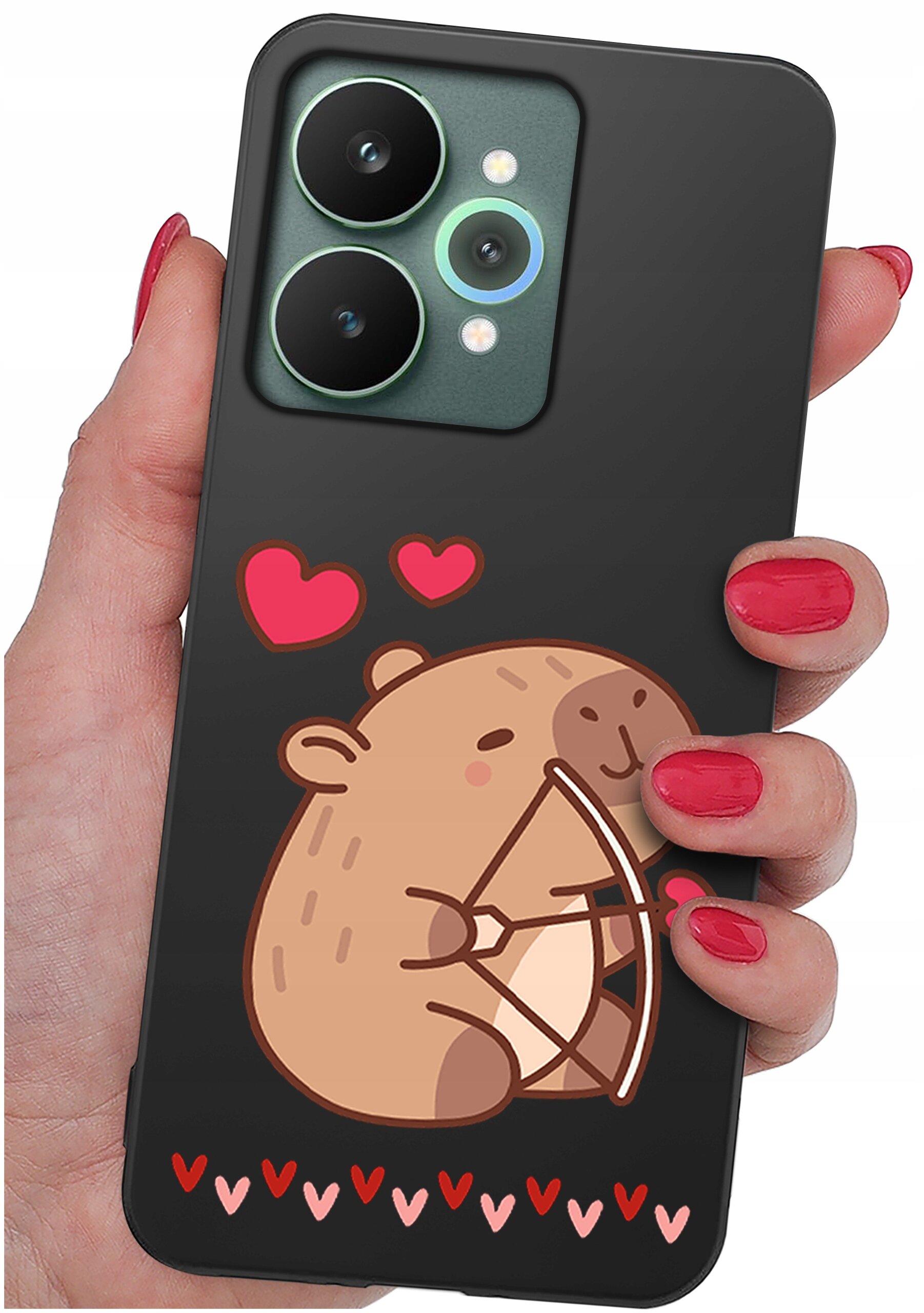 Osoba trzyma czarne etui na telefon z grafiką przedstawiającą uśmiechniętego misia z łukiem i czerwonymi serduszkami. Na dole etui znajduje się rząd małych serduszek w różnych odcieniach czerwieni i różu.