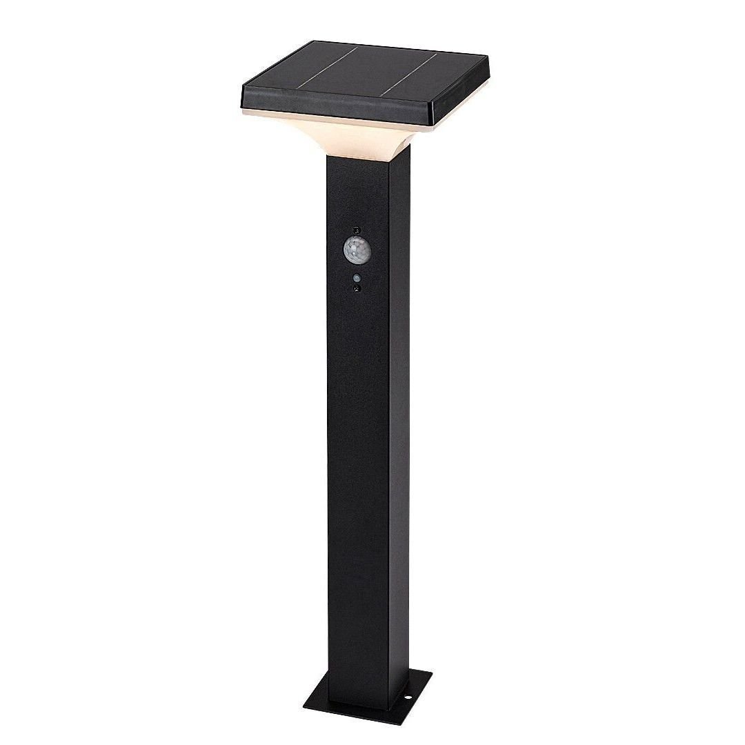 Czarna lampa solarna ogrodowa w formie słupka z płaskim, kwadratowym panelem na górze i czujnikiem ruchu na froncie. Lampa ma prosty, nowoczesny design.