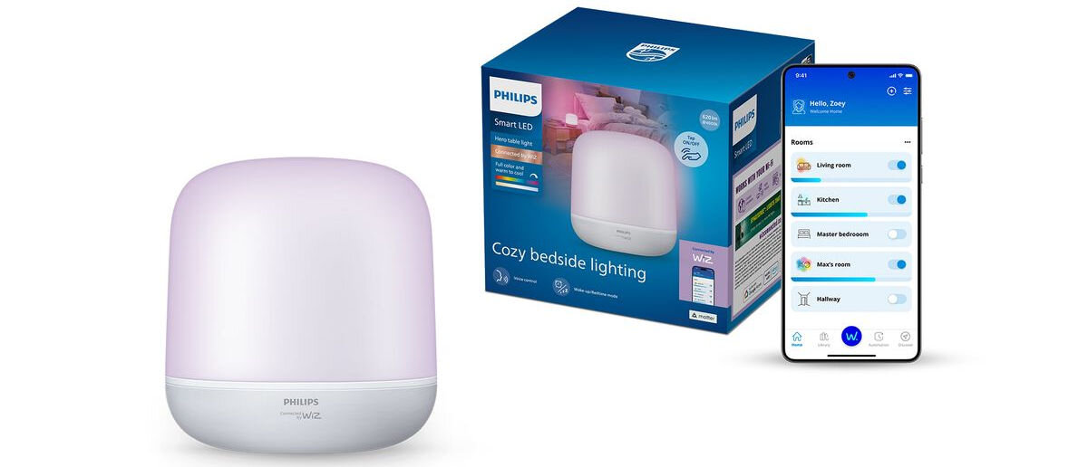Na obrazie widoczna jest biała lampa stołowa z napisem \'PHILIPS Hero Table Light WiZ\' oraz pudełko z grafiką lampy i tekstem \'Cozy bedside lighting\'. Obok znajduje się smartfon z aplikacją pokazującą różne opcje oświetlenia.