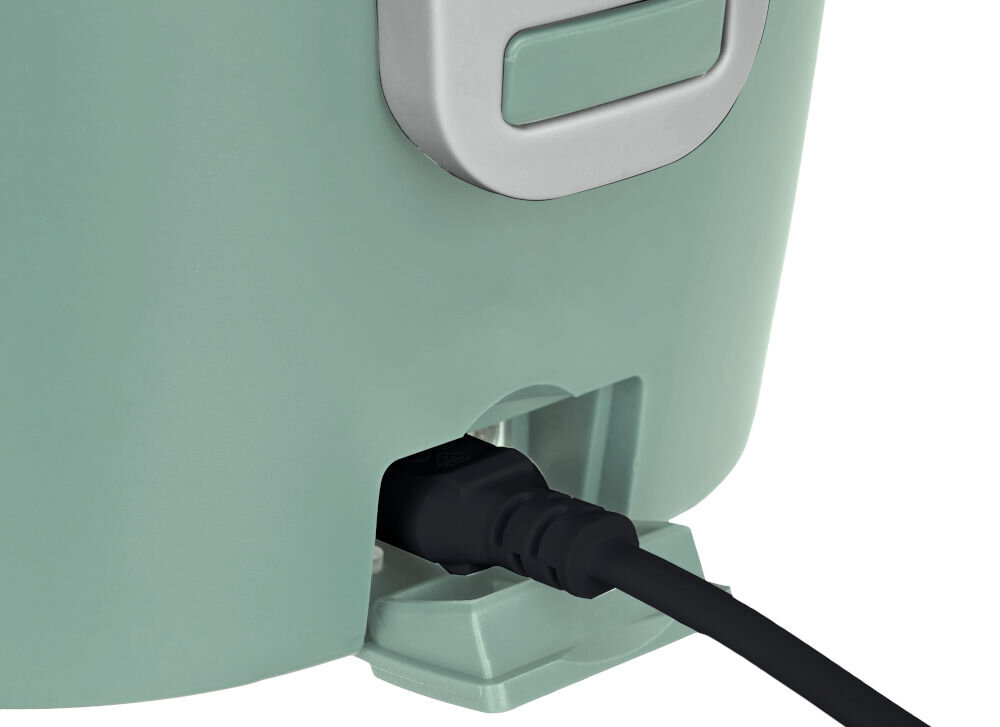Zbliżenie na zielony elektryczny lunch box z podłączonym czarnym kablem zasilającym. Widoczny jest fragment uchwytu w kolorze szarym.