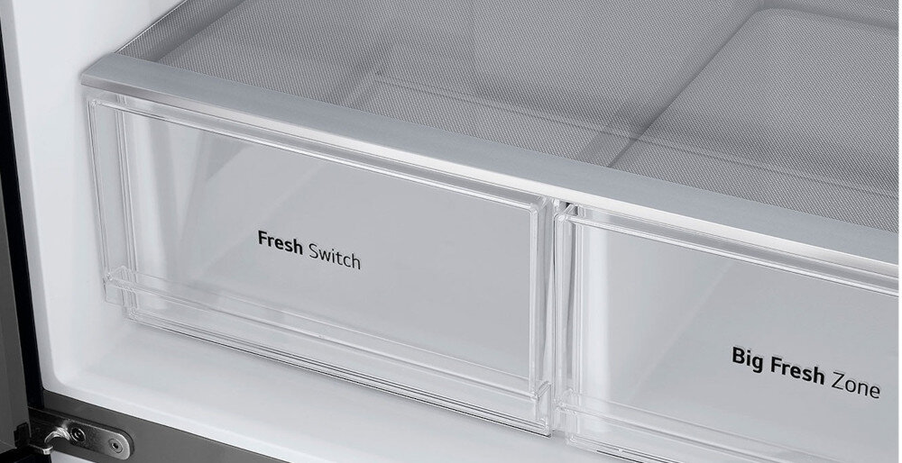 Wnętrze lodówki z dwoma przezroczystymi szufladami oznaczonymi jako \'Fresh Switch\' i \'Big Fresh Zone\'.