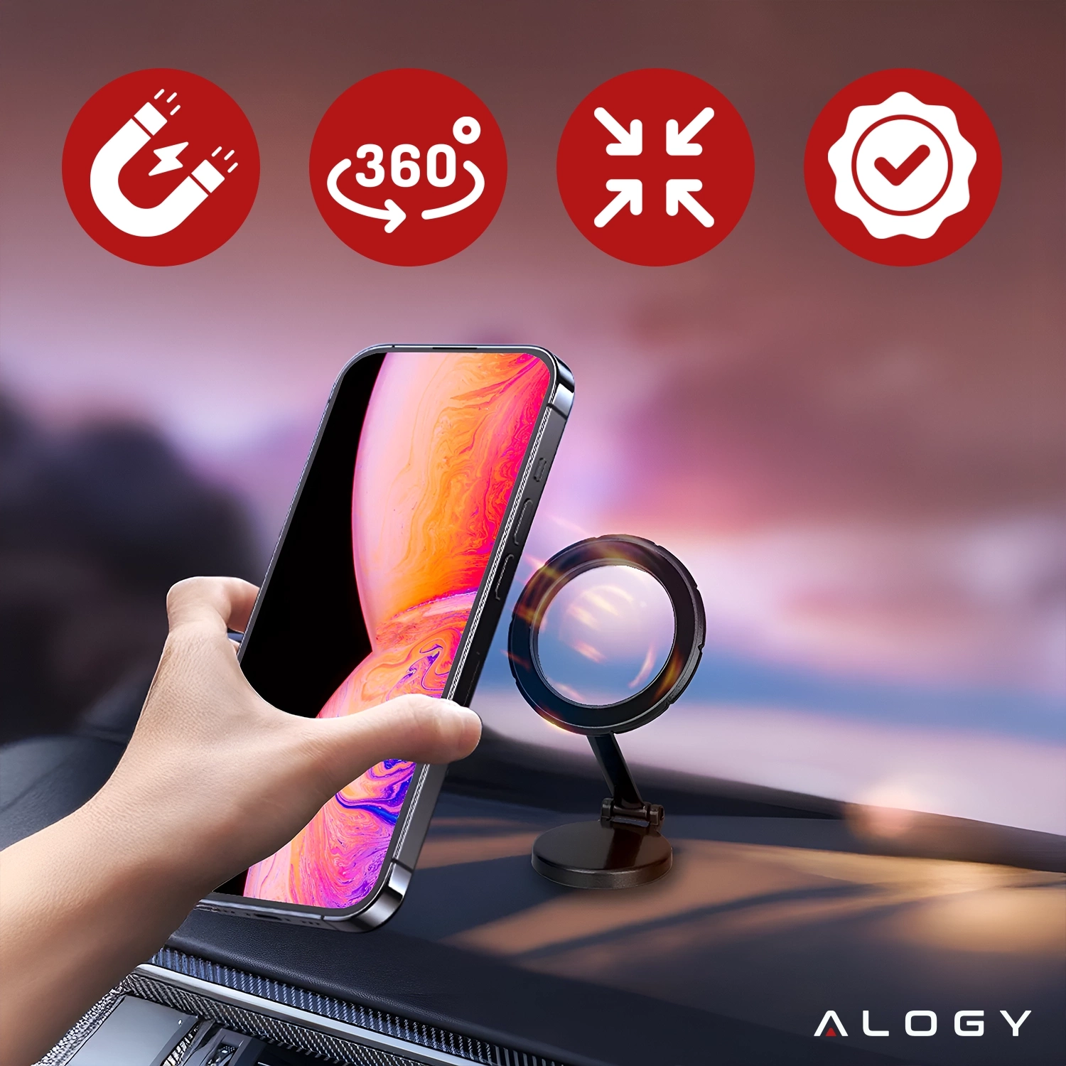 Na obrazie widać rękę trzymającą telefon przy magnetycznym uchwycie samochodowym zamontowanym na desce rozdzielczej. W tle znajdują się cztery czerwone ikony symbolizujące funkcje uchwytu oraz logo \'ALOGY\'.