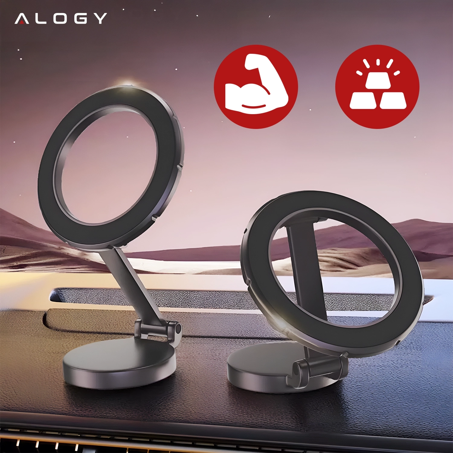 Na obrazie widoczne są dwa magnetyczne uchwyty samochodowe na telefon w kolorze czarnym, umieszczone na desce rozdzielczej. W lewym górnym rogu znajduje się logo \'ALOGY\', a w tle widoczne są dwa czerwone symbole: zgięte ramię i sztabki złota.