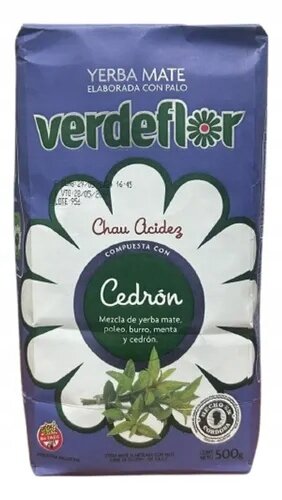 Opakowanie Yerba Mate Verdeflor Cedron 500g z dużym białym kwiatem na fioletowym tle. Widoczny tekst: \'Yerba Mate Elaborada Con Palo\', \'Chau Acidez\', \'Compuesta Con Cedrón\', \'Mezcla de yerba mate, poleo, burro, menta y cedrón\'.