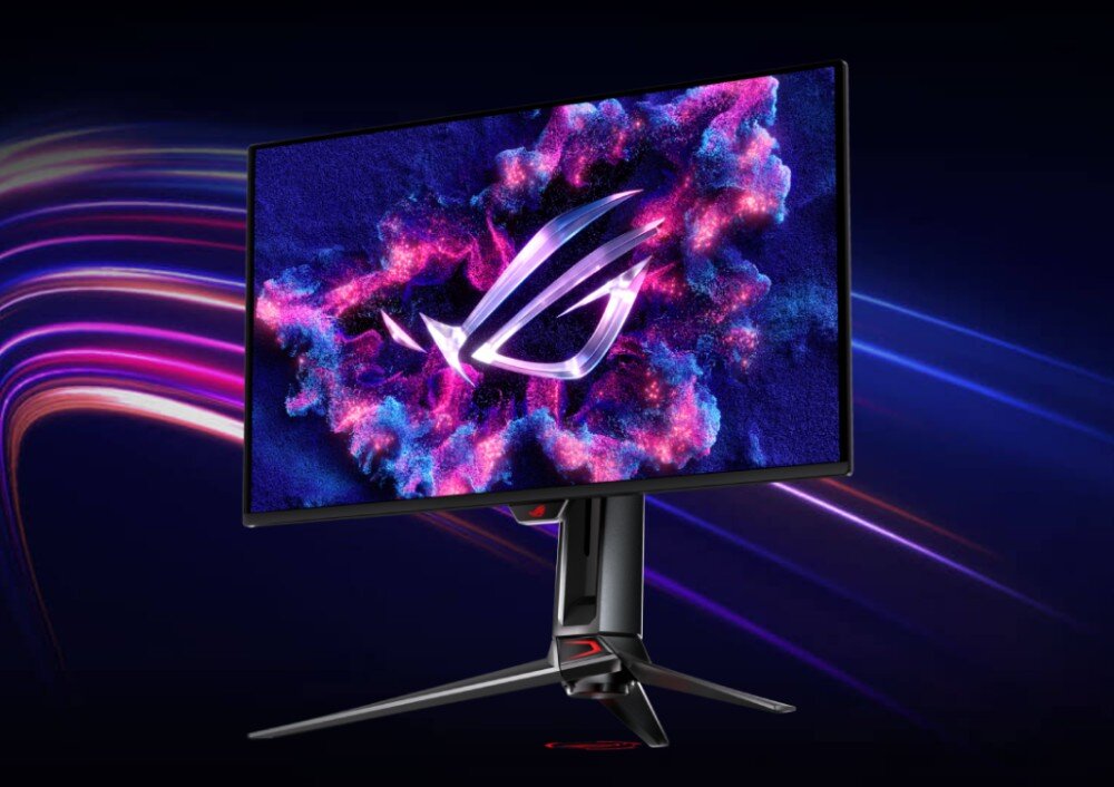 Monitor z cienkimi ramkami wyświetla kolorową grafikę z logo przypominającym literę \'G\'. Stojak monitora ma futurystyczny design z czerwonymi akcentami.