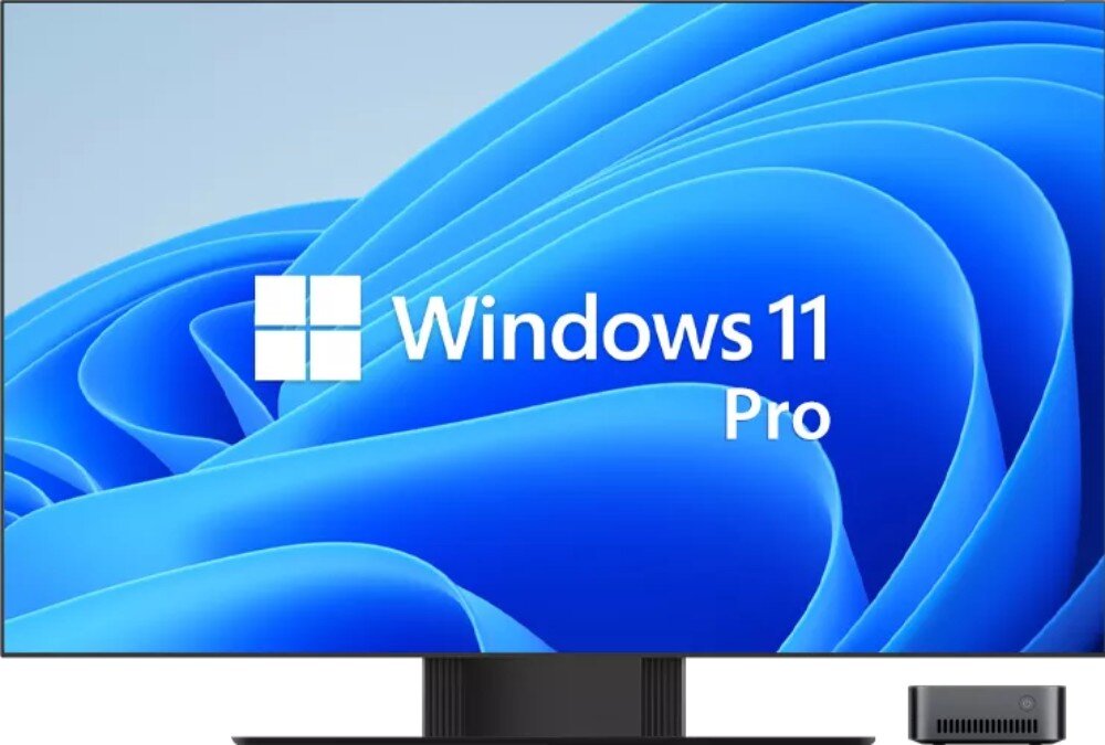 Na ekranie widoczny jest napis \'Windows 11 Pro\' na tle niebieskich falistych wzorów. Obok ekranu znajduje się niewielkie urządzenie elektroniczne.