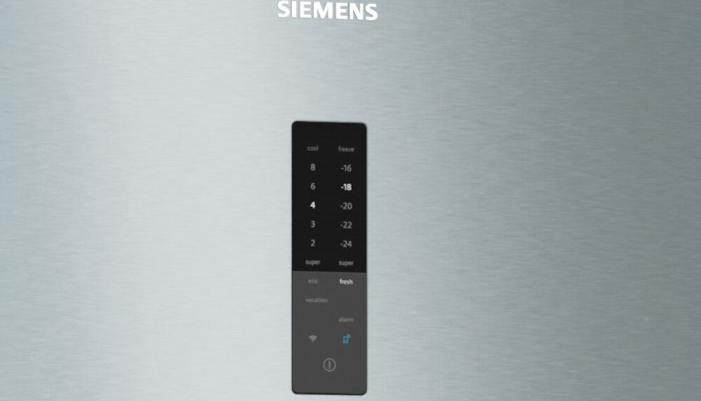 Na srebrnej powierzchni widoczny jest czarny panel sterowania z białymi oznaczeniami temperatury oraz przyciskami. Nad panelem znajduje się logo \'SIEMENS\'.