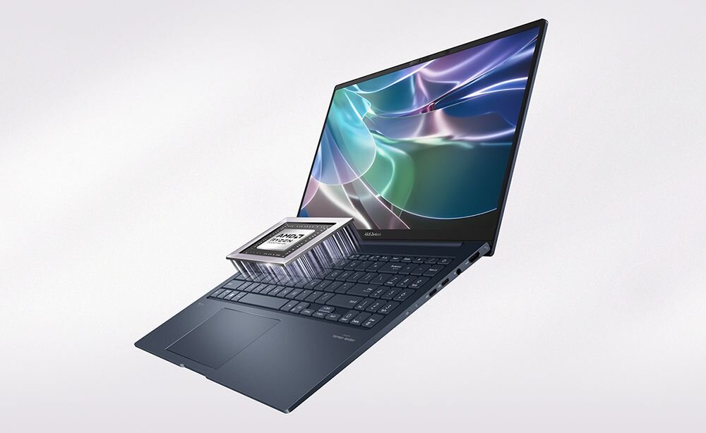Laptop z otwartym ekranem wyświetlającym kolorową grafikę. Na klawiaturze znajduje się model procesora z napisem \'AMD Ryzen\'.