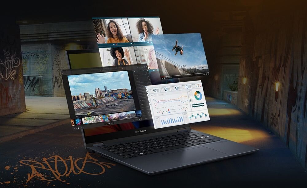 Laptop z otwartym ekranem, na którym wyświetlane są różne aplikacje, w tym wideokonferencja, edytor zdjęć i wykresy. W tle widoczny jest ciemny korytarz z graffiti na ścianach.