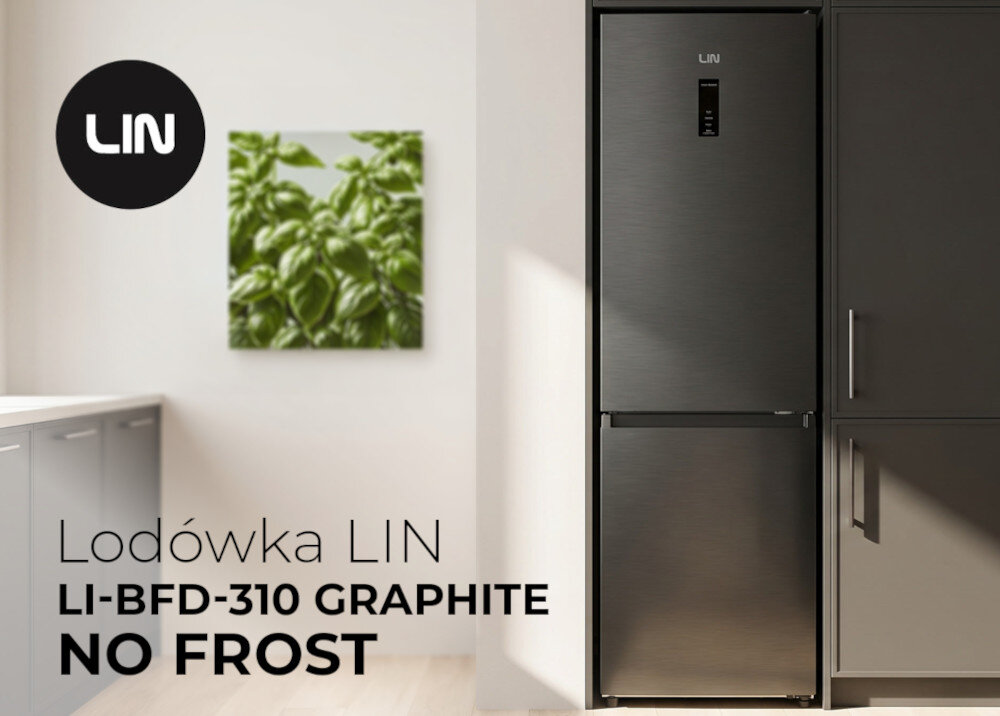 Grafitowa lodówka LIN z napisem \'LI-BFD-310 GRAPHITE NO FROST\' stoi w nowoczesnej kuchni. Na ścianie wisi obraz z zielonymi liśćmi, a obok lodówki widoczne są szafki kuchenne.