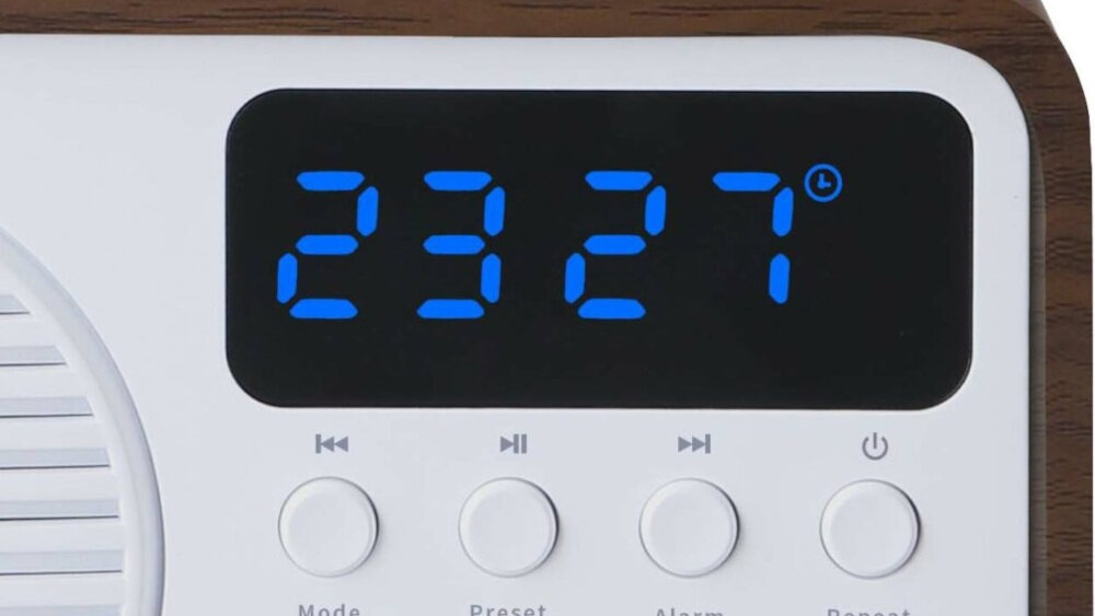 Wyświetlacz cyfrowy pokazuje godzinę 23:27, poniżej znajdują się przyciski sterujące z oznaczeniami: Mode, Preset, Alarm, Repeat.