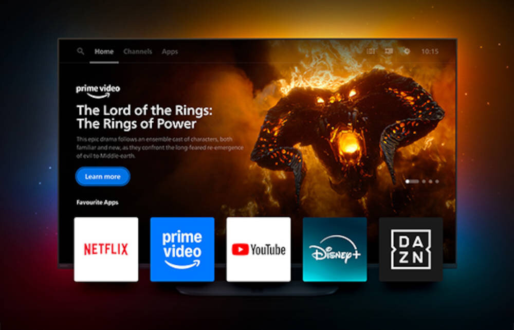 Telewizor wyświetla ekran główny aplikacji Prime Video z grafiką promującą \'The Lord of the Rings: The Rings of Power\'. Poniżej widoczne są ikony aplikacji: Netflix, Prime Video, YouTube, Disney+, DAZN.
