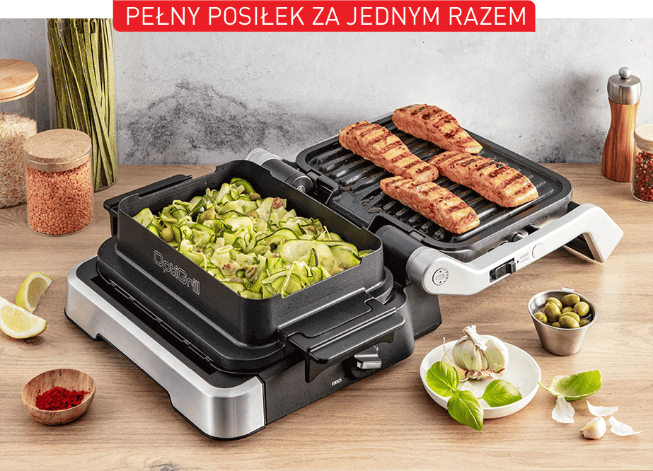 Na drewnianym blacie stoi grill elektryczny z dwoma powierzchniami: jedna z grillowanymi kawałkami mięsa, druga z warzywami. Nad grillem widoczny jest napis \'PEŁNY POSIŁEK ZA JEDNYM RAZEM\'.