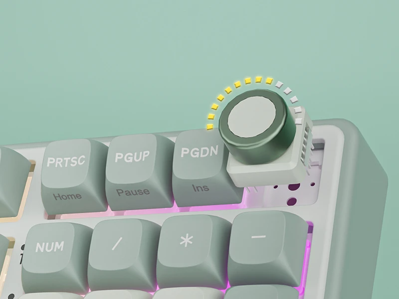 Fragment klawiatury z widocznymi klawiszami: PRTSC, PGUP, PGDN, Home, Pause, Ins, NUM, /, *, oraz pokrętłem z żółtymi wskaźnikami świetlnymi.