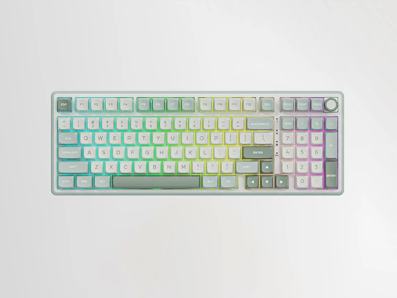 Klawiatura mechaniczna z kolorowymi klawiszami w odcieniach zieleni, żółci i fioletu. Widoczne są standardowe klawisze QWERTY oraz dodatkowe klawisze funkcyjne i numeryczne.