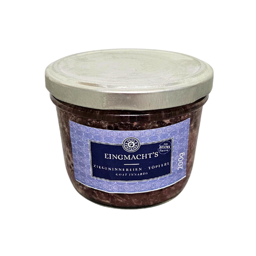 Słoik z metalową pokrywką zawierający produkt oznaczony etykietą \'EINGMACHT\'S ZIEGENINNEREN - TOPFER GOAT INNARDS\'.