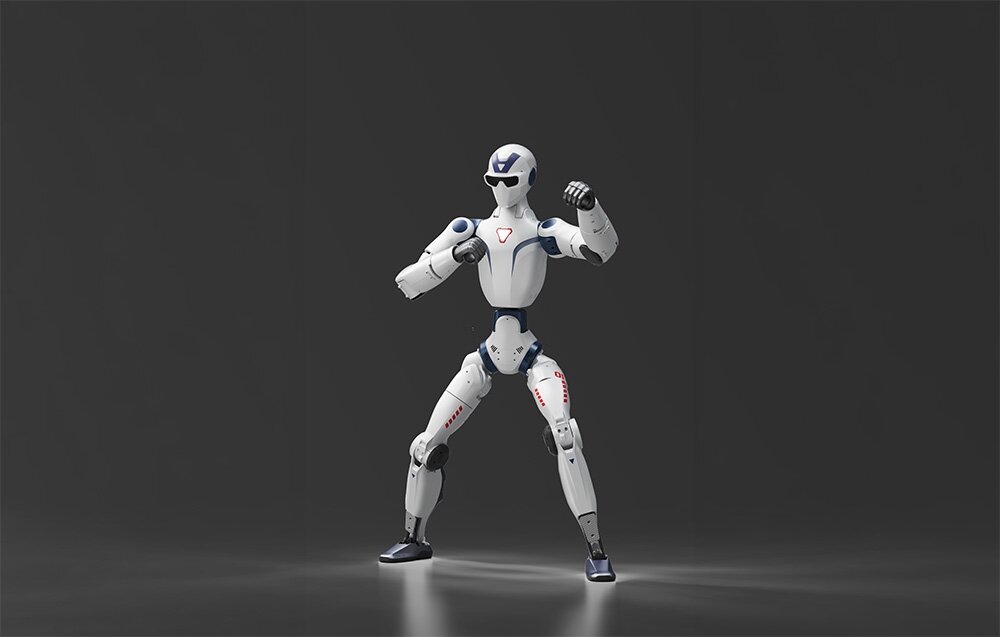 Robot humanoidalny robi przewrót na jasnym placu przed nowoczesnym kompleksem budynków z czerwonym elementem