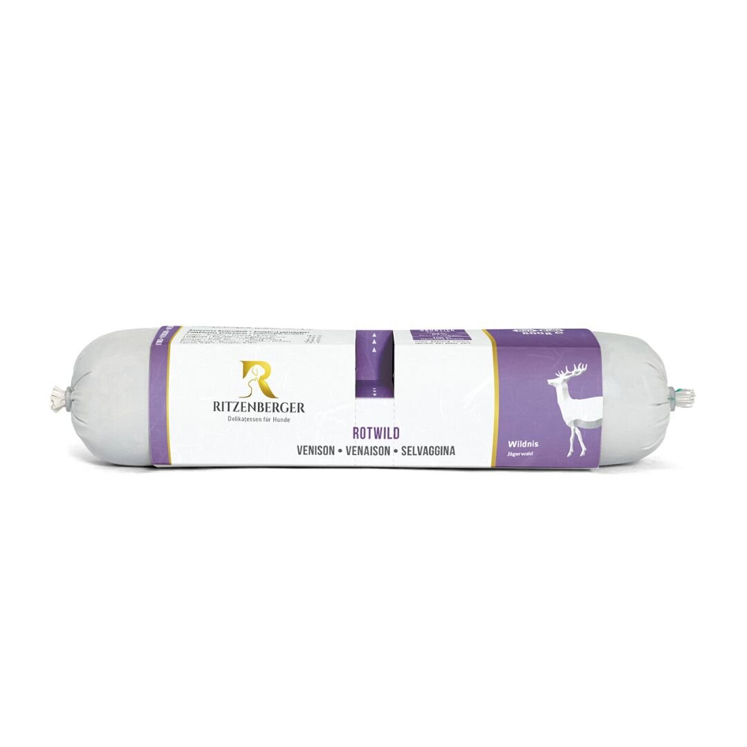 Produkt w formie podłużnego opakowania z etykietą w kolorach białym i fioletowym, z logo Ritzenberger oraz grafiką jelenia. Na etykiecie widnieje tekst: \'ROT WILD VENISON - VENAISON - SELVAGGINA\'.