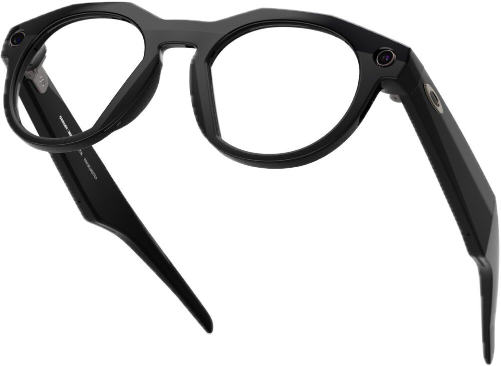 Czarne okulary z grubymi oprawkami i zausznikami, posiadające okrągłe soczewki. Na zauszniku widoczny jest napis \'OAKLEY\'.