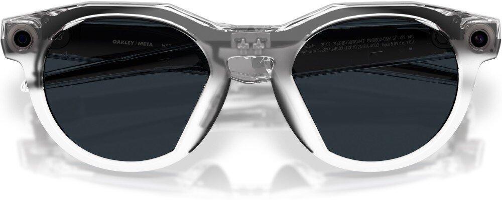 Przezroczyste okulary przeciwsłoneczne z ciemnymi soczewkami i napisem \'OAKLEY META\' na zauszniku.