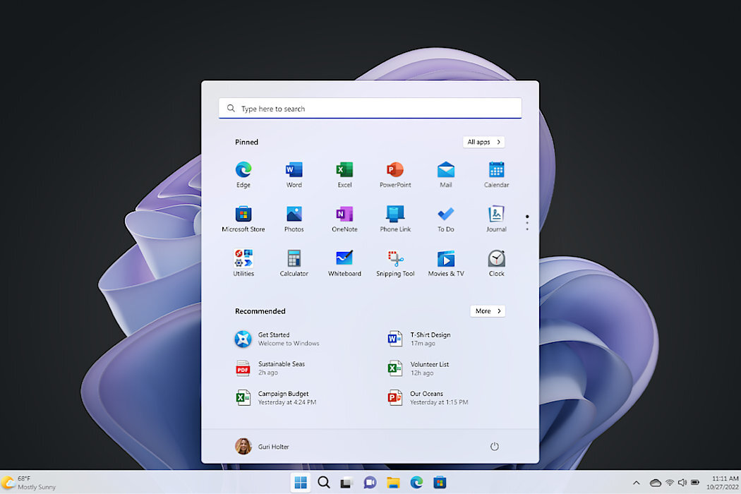 Ekran komputera z otwartym menu Start systemu Windows 11, pokazującym przypięte aplikacje takie jak Edge, Word, Excel, PowerPoint, Mail i inne. W tle widoczna jest abstrakcyjna, fioletowa grafika.
