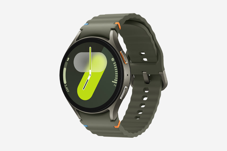 Galaxy Watch7 Zegarek z okrągłym wyświetlaczem, na którym widoczny jest abstrakcyjny wzór w kolorach zielonym i szarym. Pasek zegarka jest w kolorze oliwkowym z pomarańczowymi akcentami.