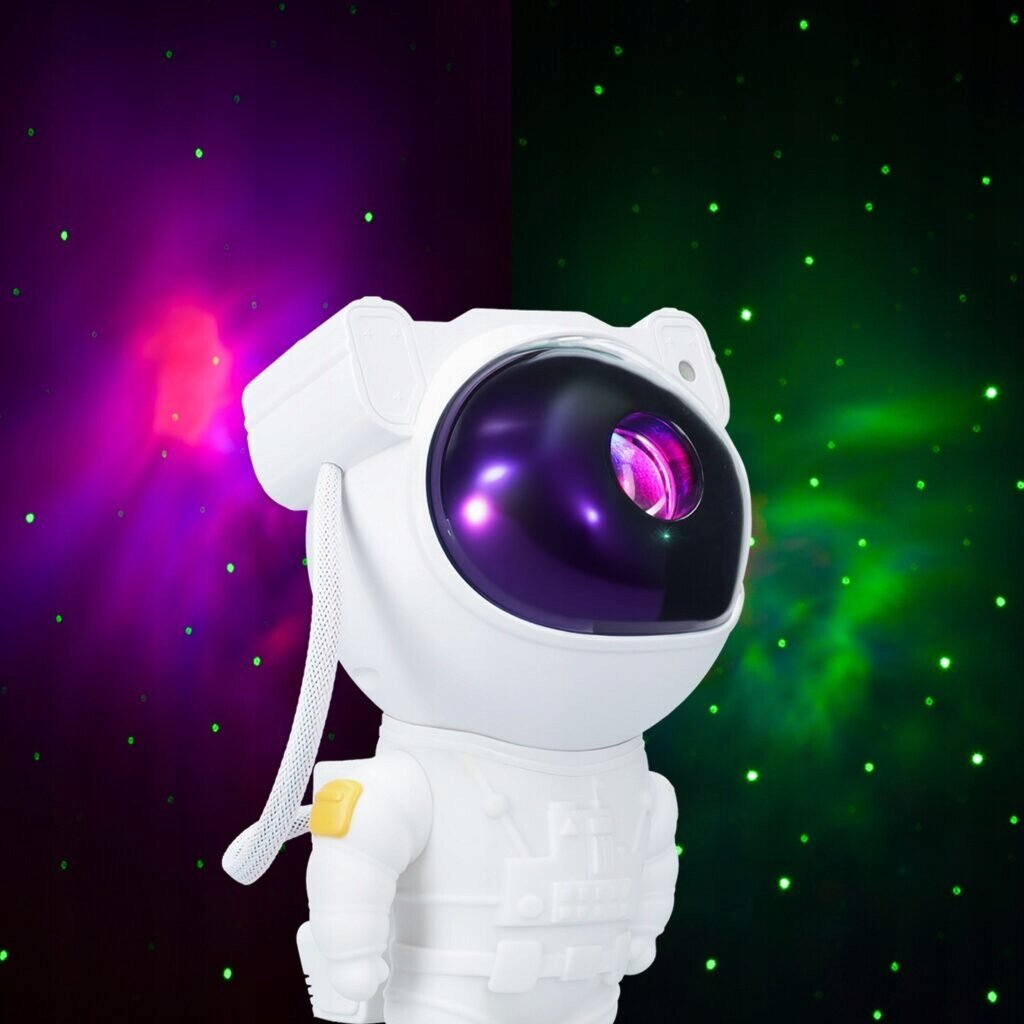 Biała figurka astronauty z dużym, ciemnym wizjerem, przez który widać kolorowe światło. Tło jest ciemne z zielonymi i fioletowymi punktami świetlnymi, przypominającymi gwiazdy.