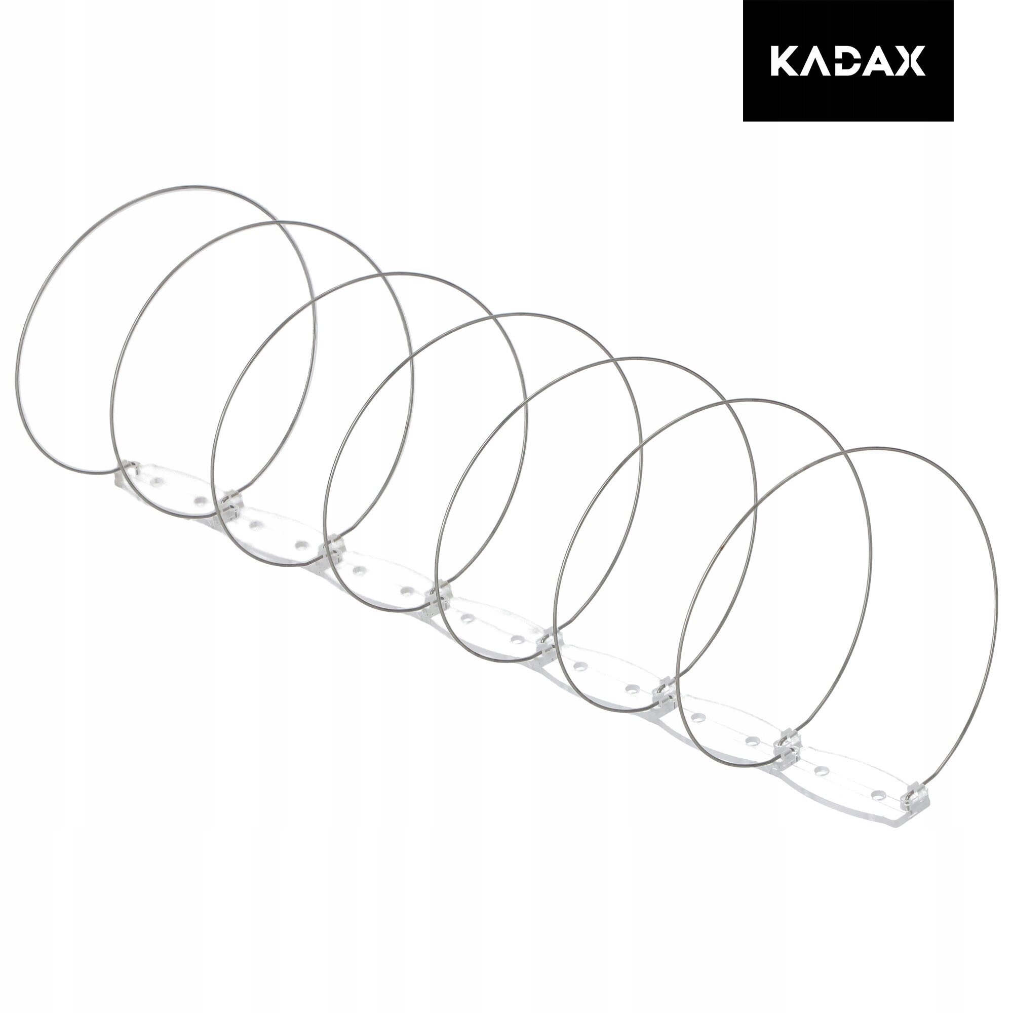 Na obrazie widoczne są metalowe spirale zamontowane na przezroczystej podstawie, służące jako odstraszacz ptaków. W prawym górnym rogu znajduje się logo z napisem \'KADAX\'.