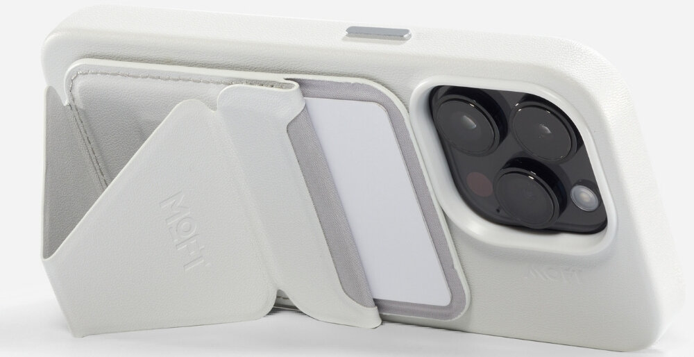 Szary portfel MagSafe przymocowany do tylnej części białego etui na telefon, z widocznym logo \'MOFT\'.