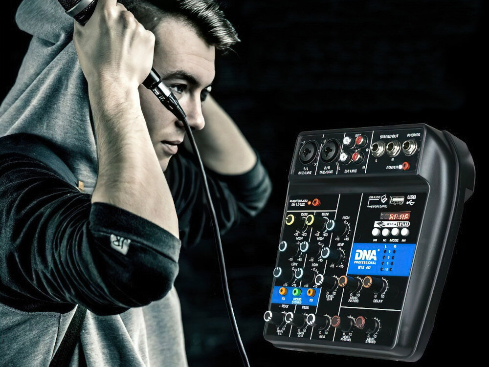 Osoba trzyma mikrofon przy uchu, obok widoczny jest mikser audio z napisem \'DNA PROFESSIONAL MIX 4U\'. Mikser ma różne pokrętła i złącza, a na panelu widoczne są oznaczenia i przyciski.