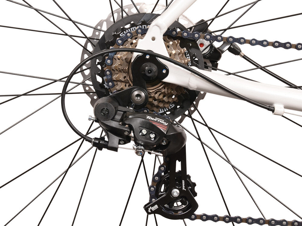 Zdjęcie przedstawia mechanizm tylnej przerzutki rowerowej z widocznym napisem \'Tourney\' oraz zębatki z logo \'Shimano\'.