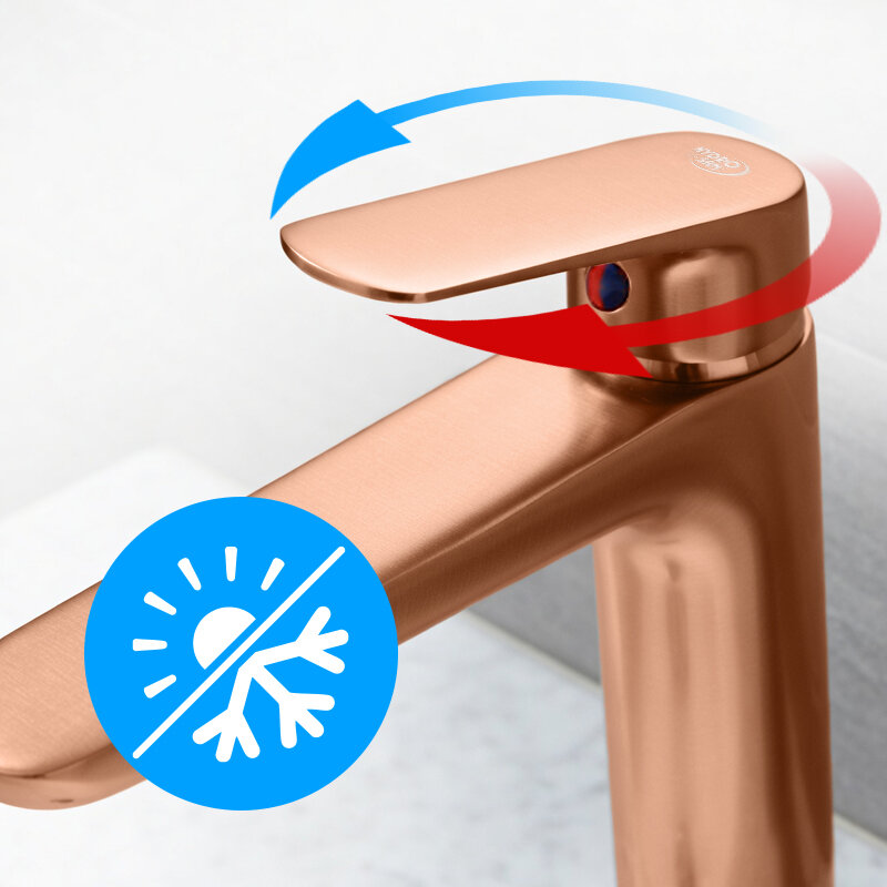 Bateria umywalkowa w kolorze szczotkowanej miedzi z widocznym symbolem regulacji temperatury w postaci niebiesko-czerwonej strzałki. Na baterii znajduje się niebieski symbol słońca i płatka śniegu.