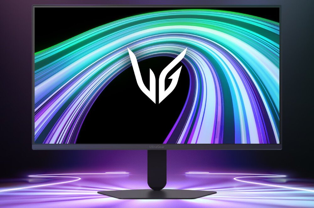 Monitor z wyświetlaczem pokazującym kolorowe, zakrzywione linie na czarnym tle oraz logo \'VG\'.