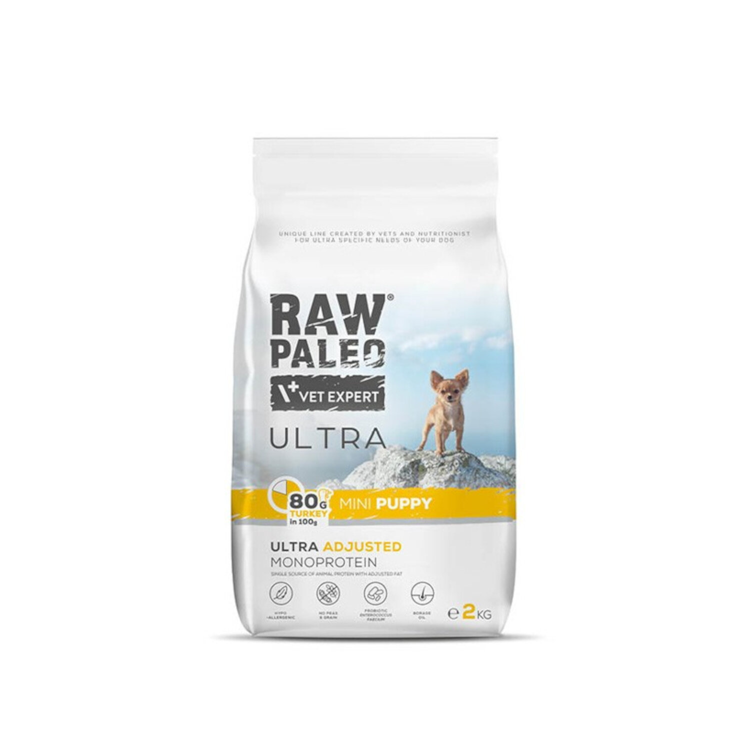 Opakowanie suchej karmy dla szczeniąt z napisem \'RAW PALEO VET EXPERT ULTRA\'. Widoczny jest mały pies stojący na skale oraz informacje o składzie i wadze 2 kg.