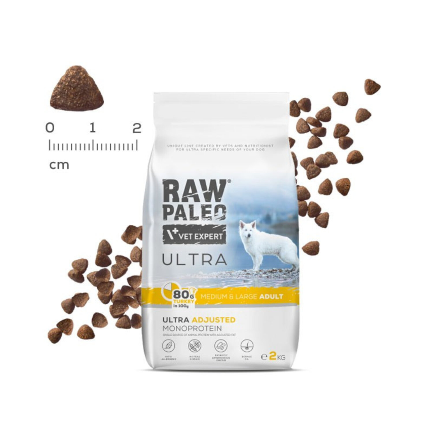 Opakowanie suchej karmy dla psów z napisem \'RAW PALEO VET EXPERT ULTRA\'. Obok widoczne są granulki karmy oraz miarka w centymetrach.