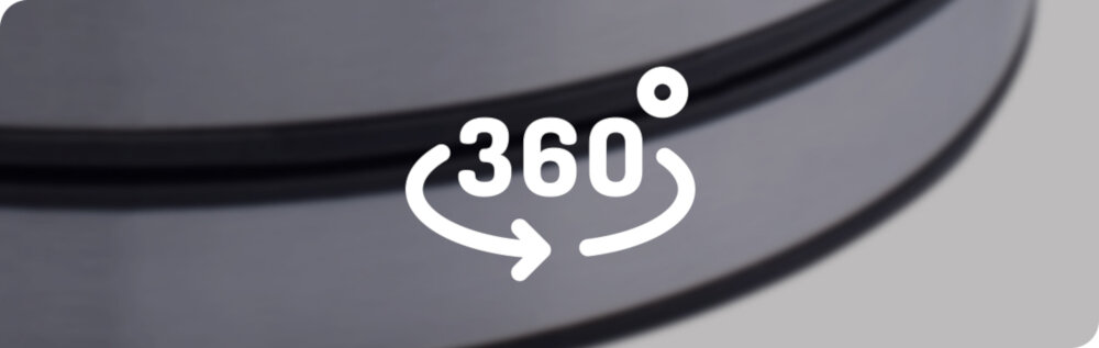 Obraz przedstawia fragment okrągłego, metalicznego przedmiotu z symbolem \'360°\' i strzałką wskazującą obrót.