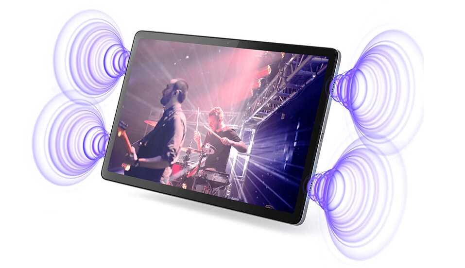 Tablet wyświetla obraz koncertu z muzykami na scenie, otoczony efektami dźwiękowymi w postaci fal. Ekran urządzenia jest jasny i kolorowy.