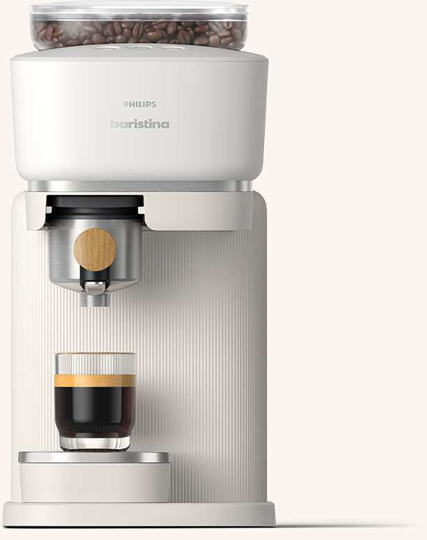 Na obrazie widoczny jest ekspres do kawy z filiżanką espresso. Na urządzeniu znajduje się logo \'PHILIPS baristina\'.