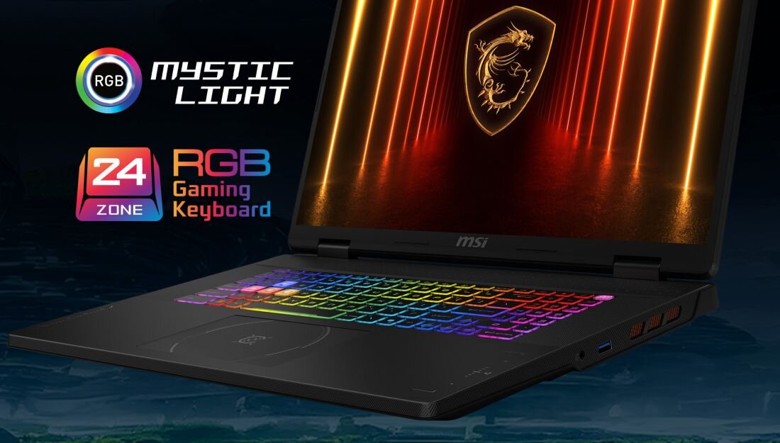 Laptop z podświetlaną klawiaturą RGB i logo smoka na ekranie. Obok widoczne napisy: \'RGB Mystic Light\' oraz \'24 Zone RGB Gaming Keyboard\'.